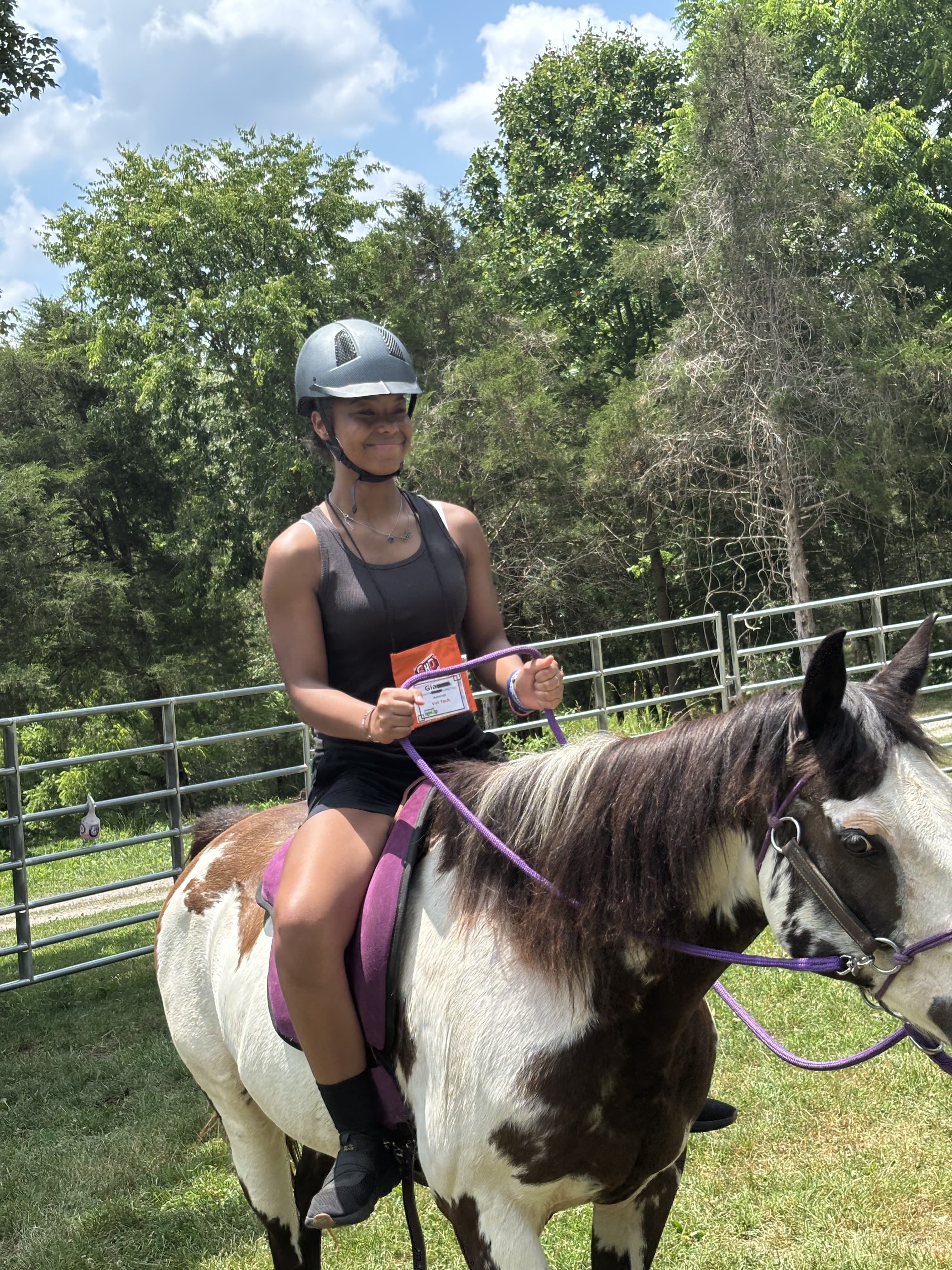 student riding a horse