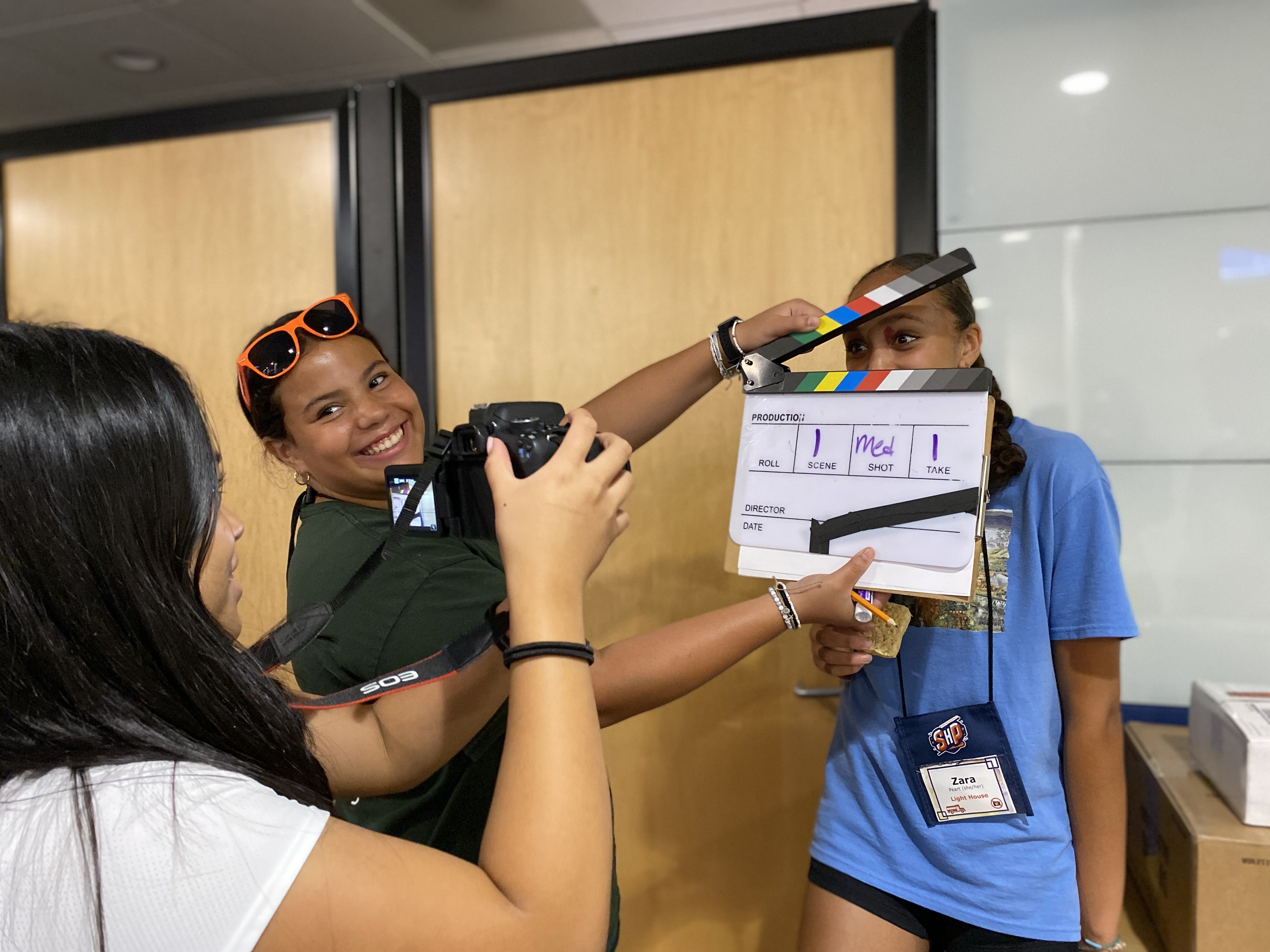 Students take a silly photo with film slate