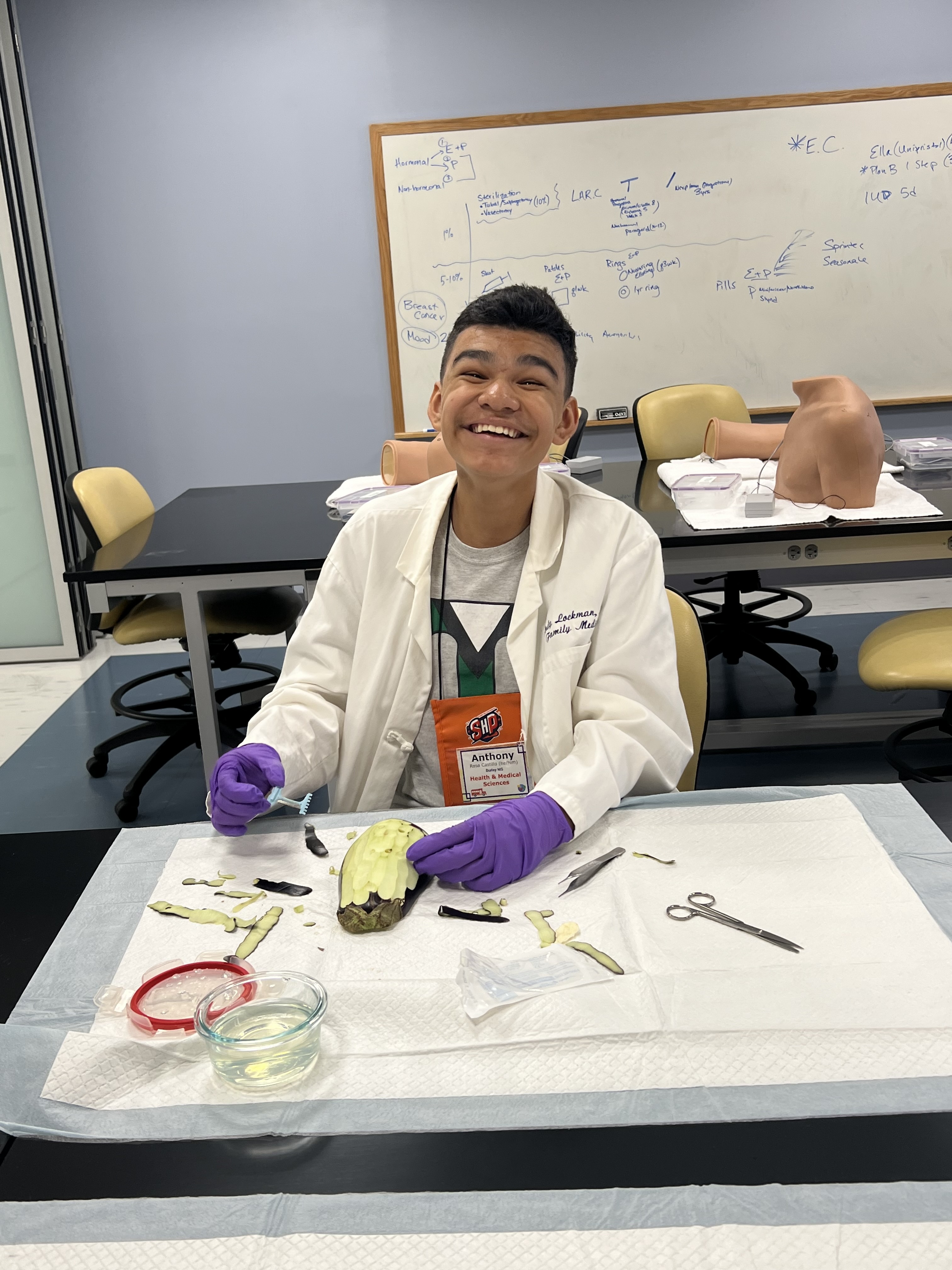 Students smiles while dissecting an eggplant