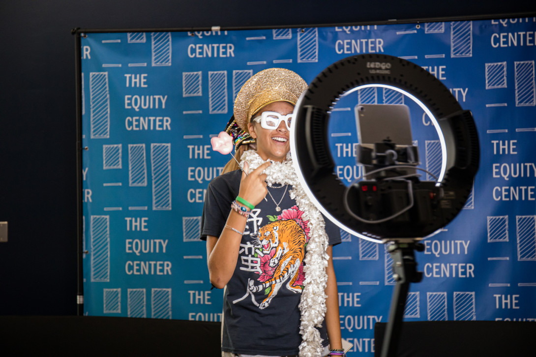 SHP Scholar poses with props in a photo booth.