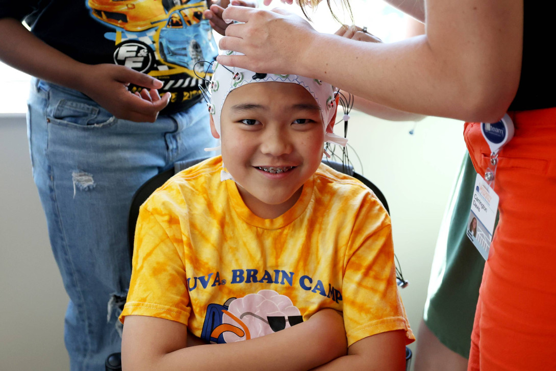 Child trying on a Electroencephalogram (EEG) cap