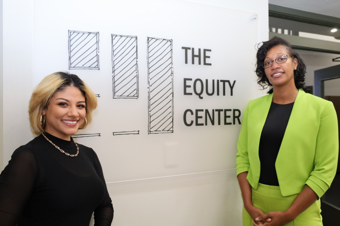 2024-2025 Community Fellows-in-Residence pose next to The Equity Center sign.